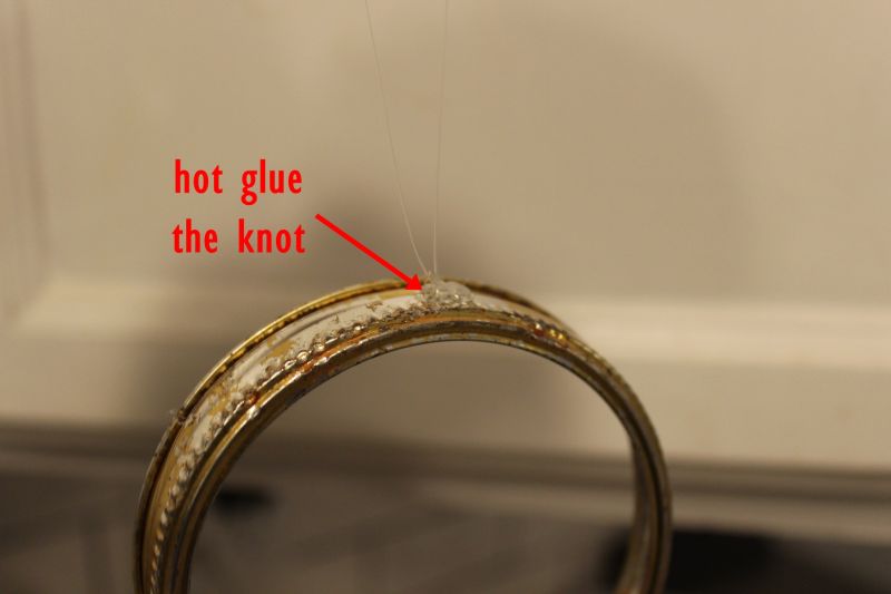 stick a small dab of glue on the outside edge